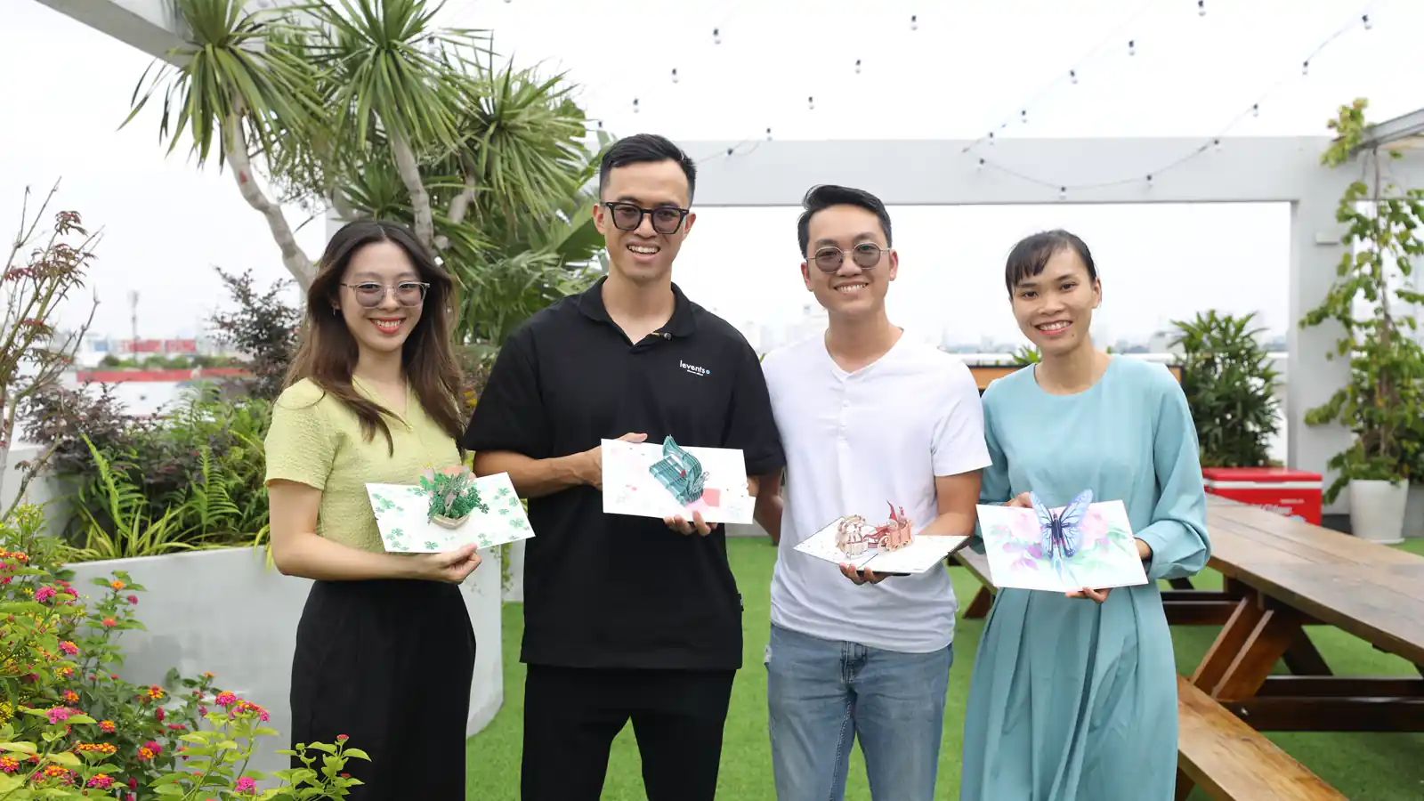 Teammates on a rooftop with pop-up cards